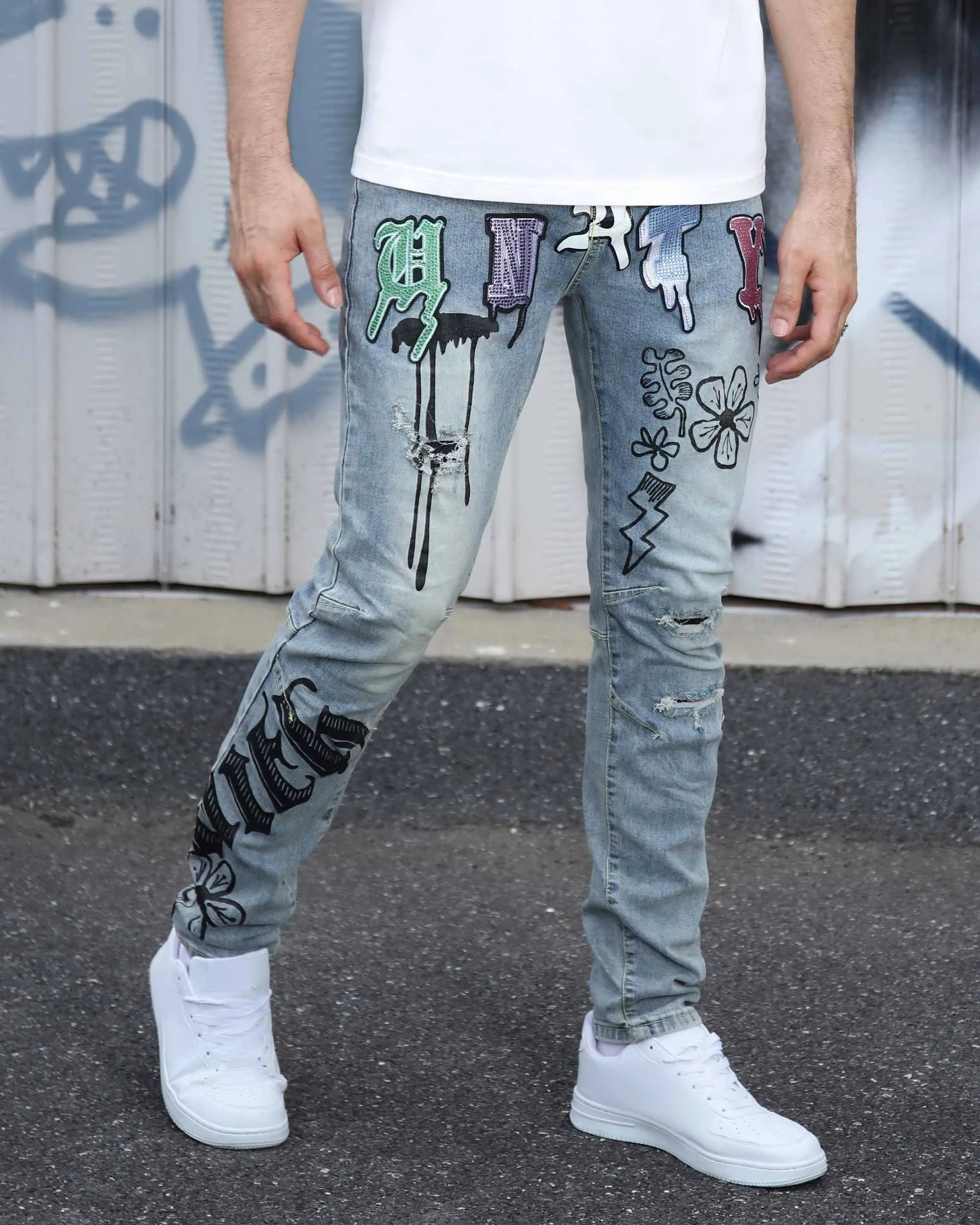 Street Art Light Wash Blue Jeans Adorned with Painted Graffiti
