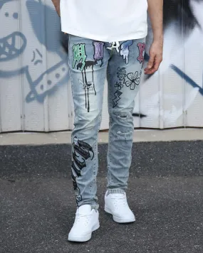 Street Art Light Wash Blue Jeans Adorned with Painted Graffiti