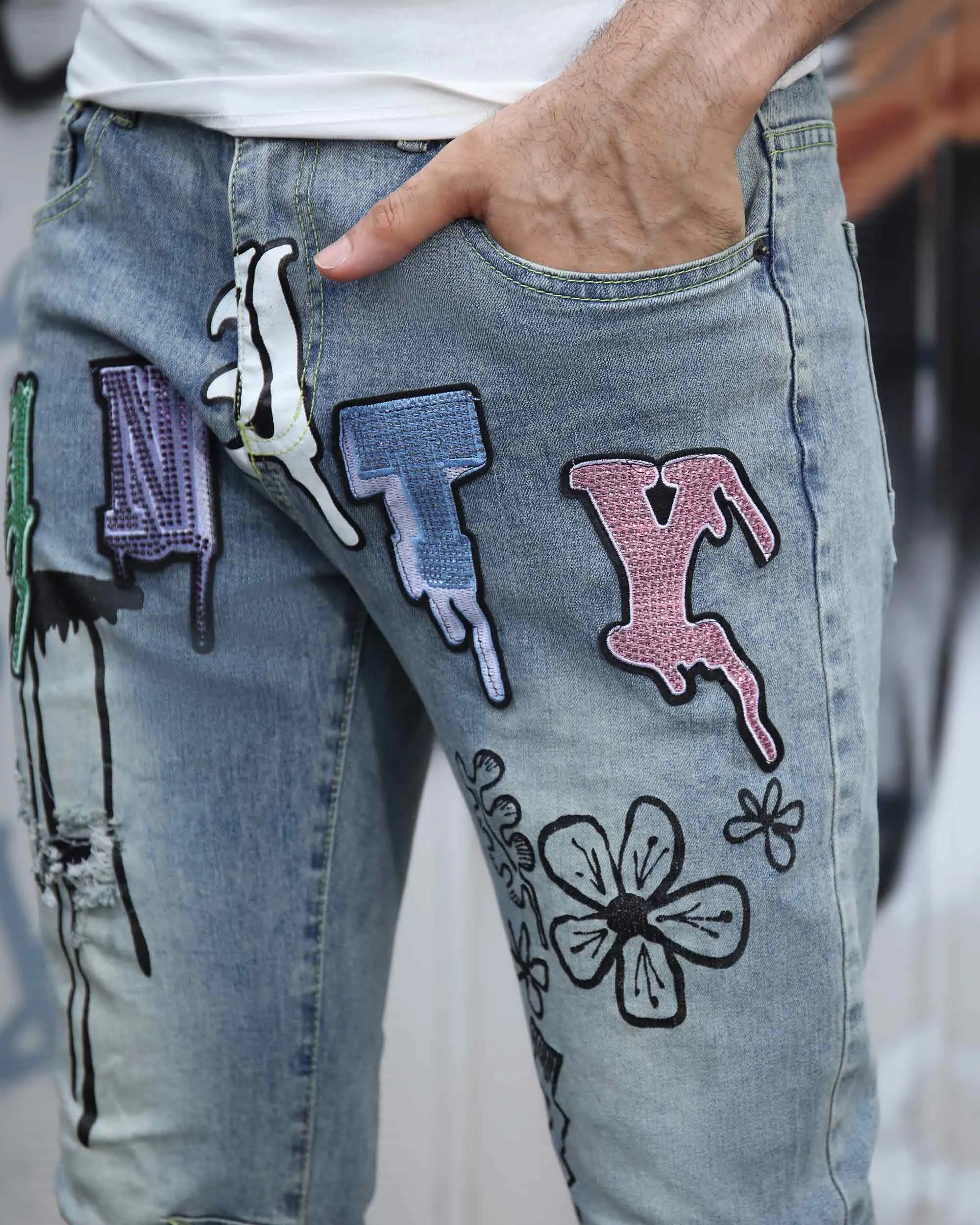 Street Art Light Wash Blue Jeans Adorned with Painted Graffiti
