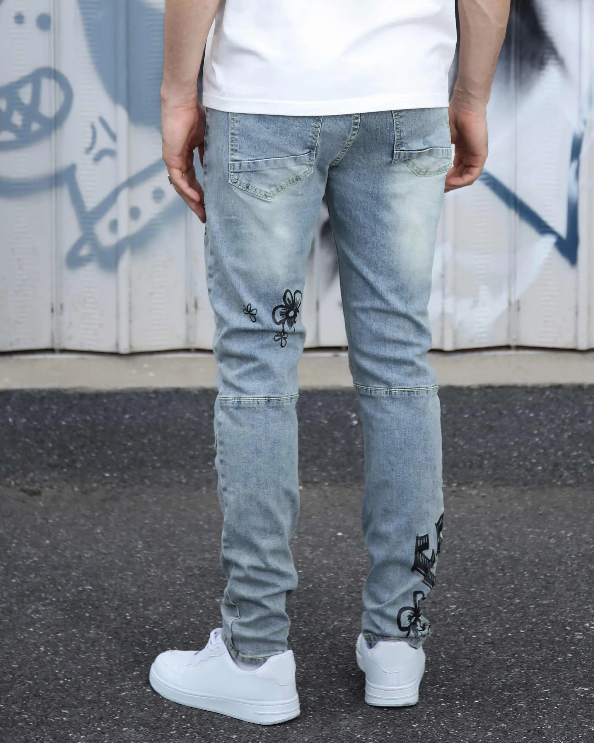 Street Art Light Wash Blue Jeans Adorned with Painted Graffiti
